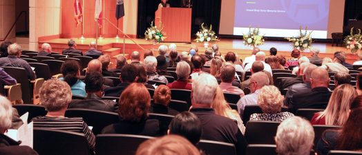people sitting down in an auditorium