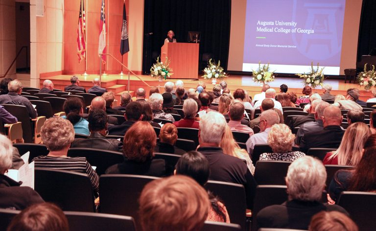 people sitting down in an auditorium