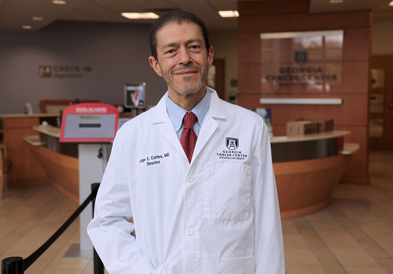 man standing in front of a medical office