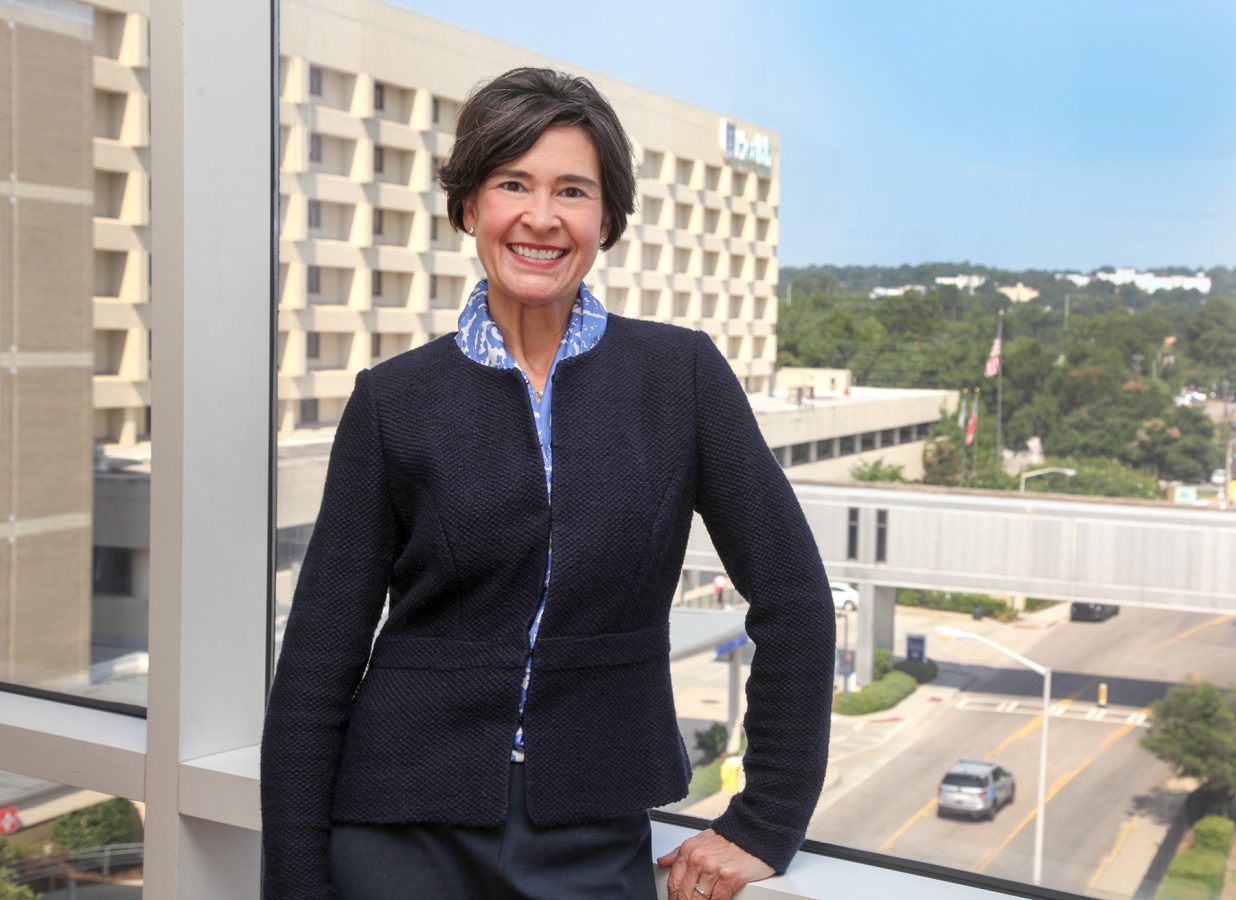 woman standing in front of a medical building