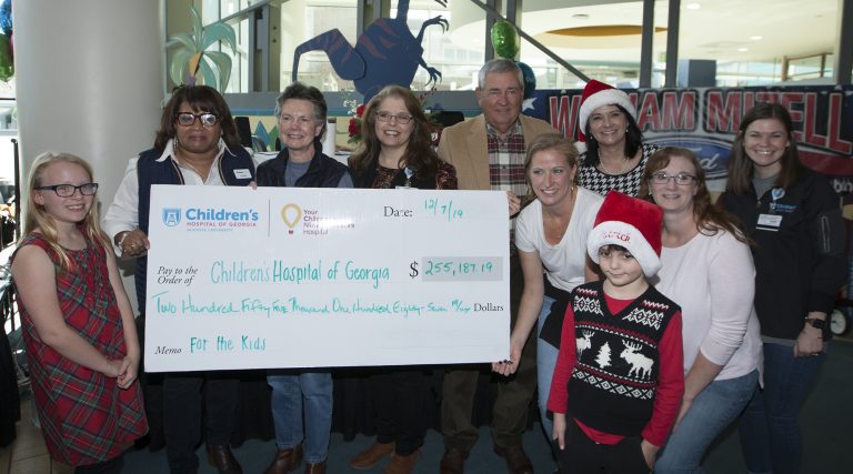 people holding a big check