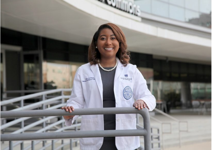 woman standing in front of a medical building