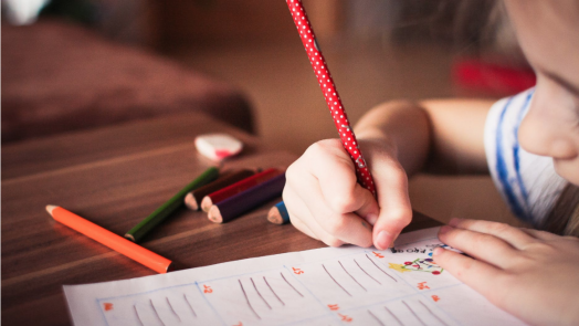 girl writing on paper