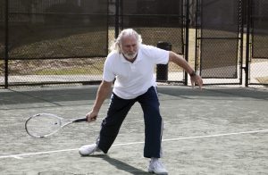 Man hitting a tennis ball.