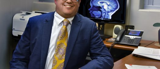 man in suit smiling at desk