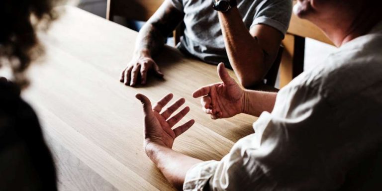 three people at table discussion