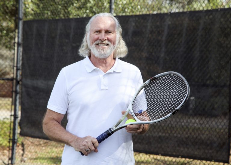 A man holding a tennis racket