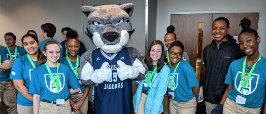 Students smiling with the university mascot