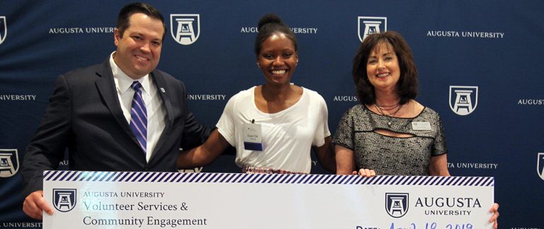 woman standing with an award