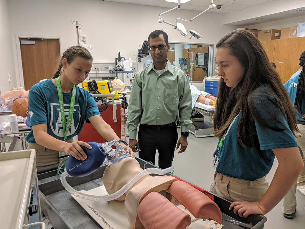 students in lab working on dummy