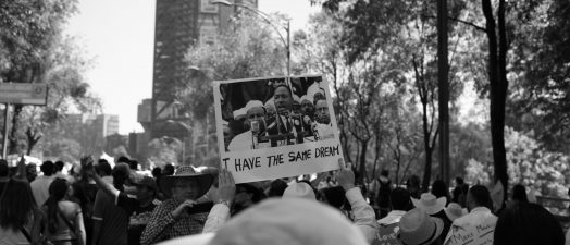 Man holding sign in crowd