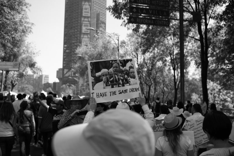 Man holding sign in crowd