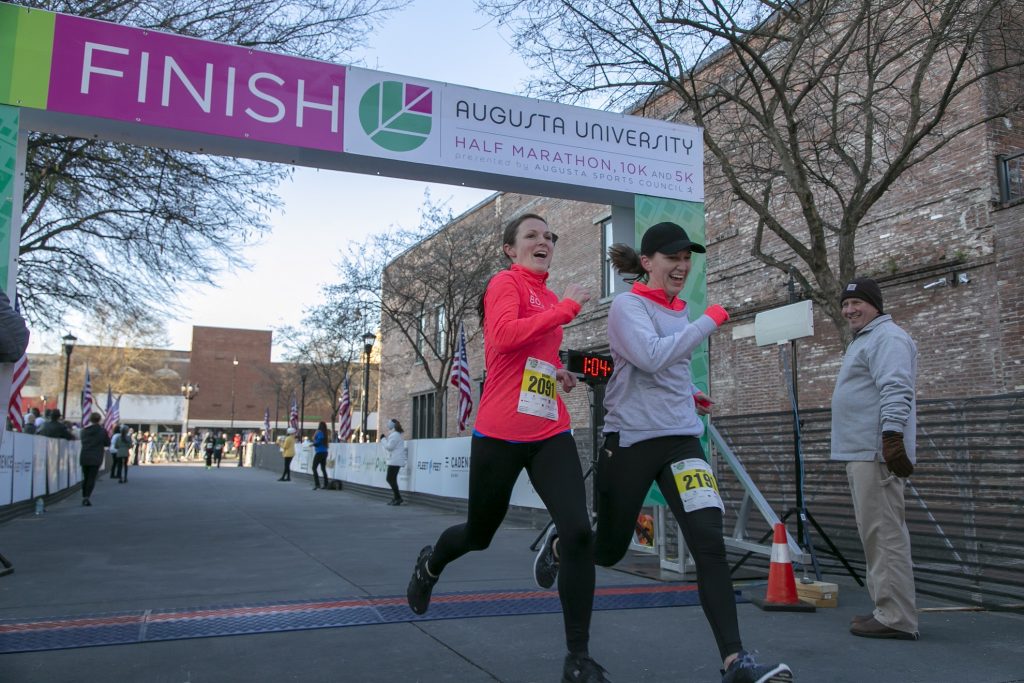 marathon runners go through finish line