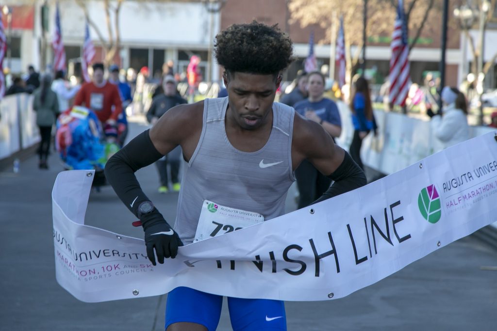 marathon runner breaks finish line