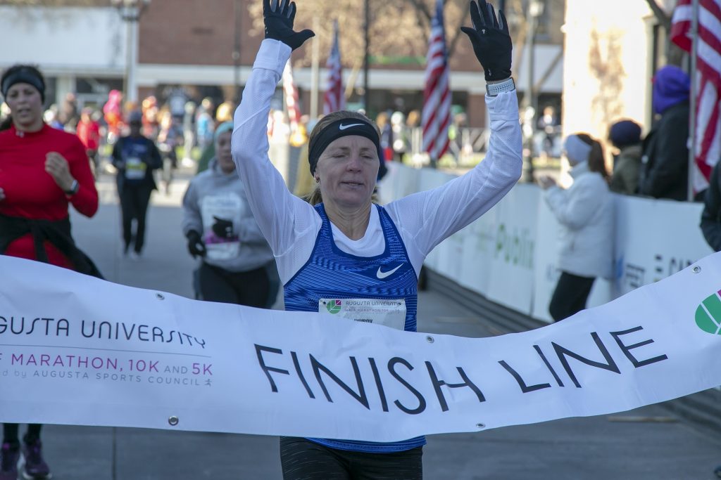 marathon runner breaks finish line