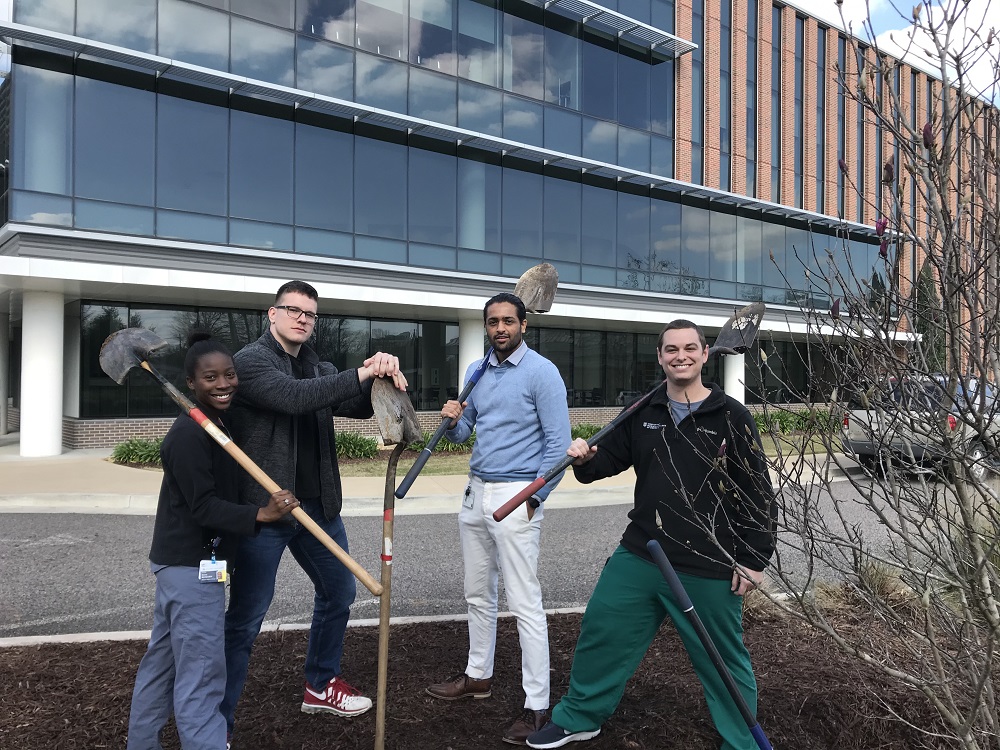 four students with shovels