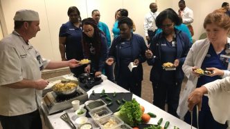 Chef serves people in serving line