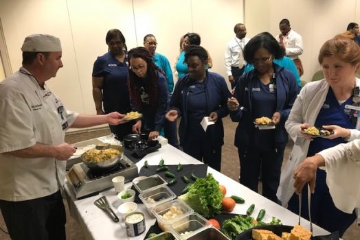 Chef serves people in serving line