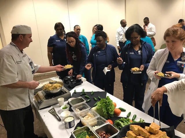 Chef serves people in serving line