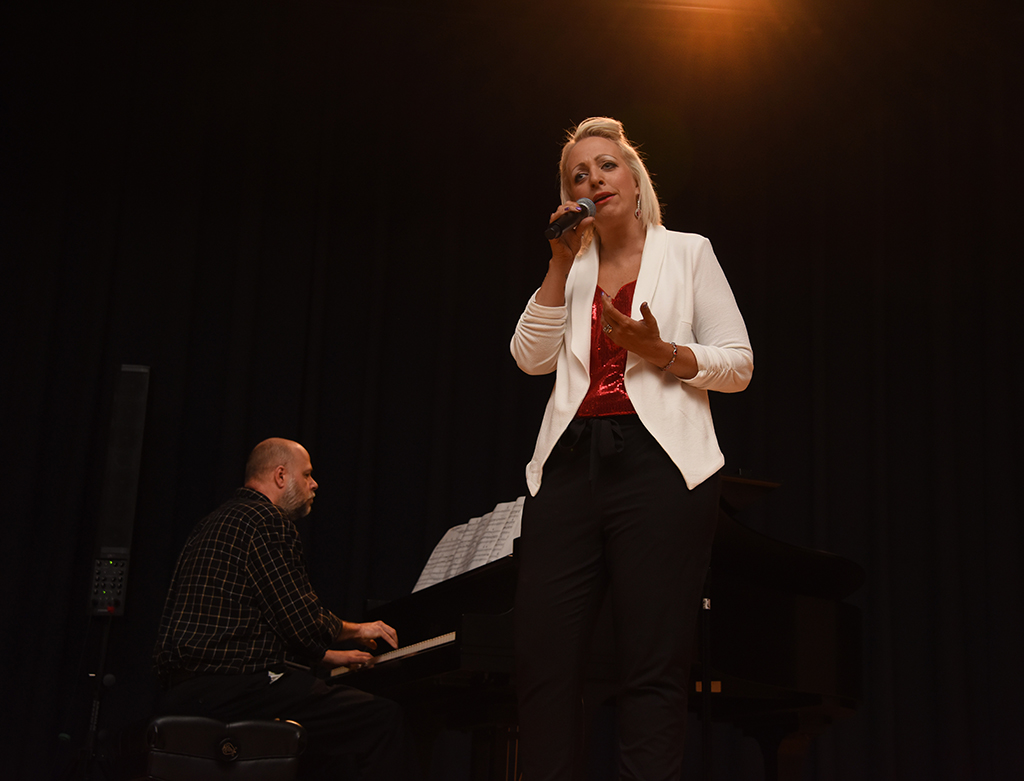 Woman singing and man playing piano