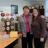 two women posed in office setting
