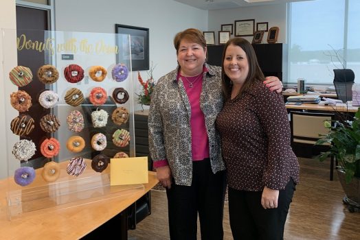 two women posed in office setting