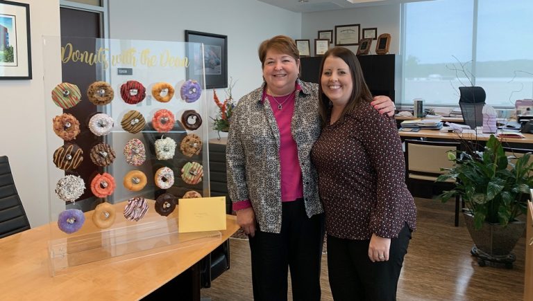two women posed in office setting