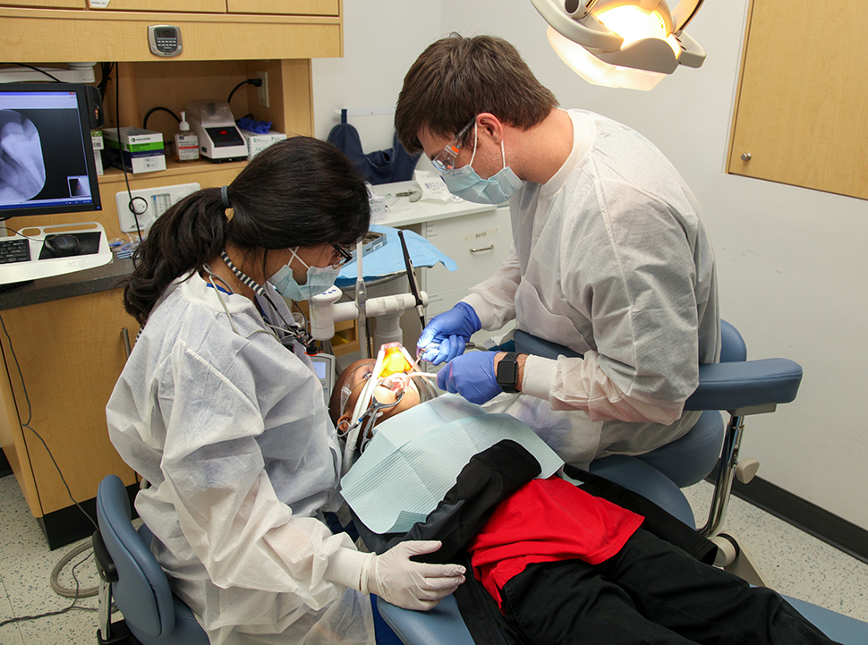 Dental students working on youth
