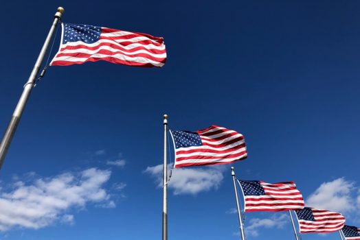 American flags waving in the sky.