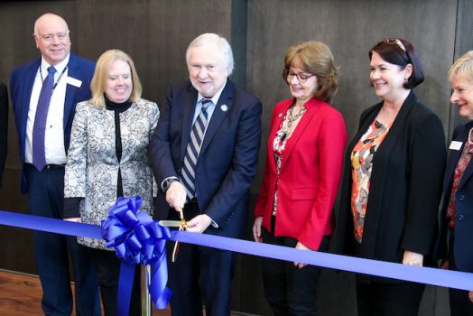 People cutting a ribbon.
