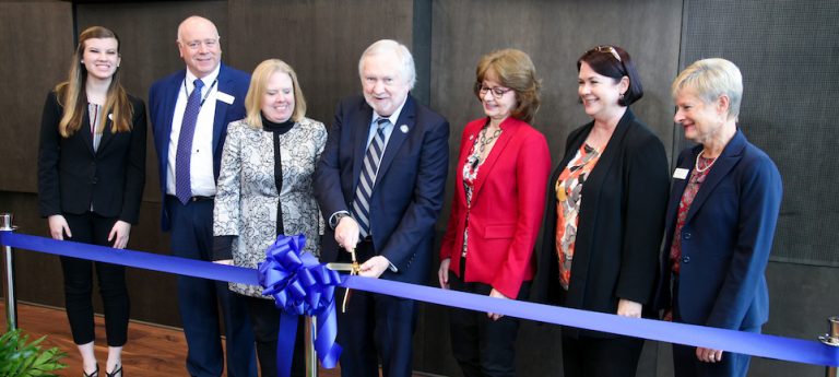 People cutting a ribbon.