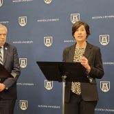 woman and man talking with podium