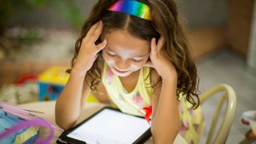 A child reads on a digital tablet.