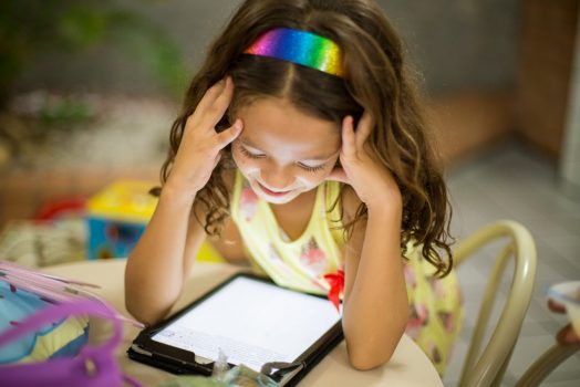 A child reads on a digital tablet.