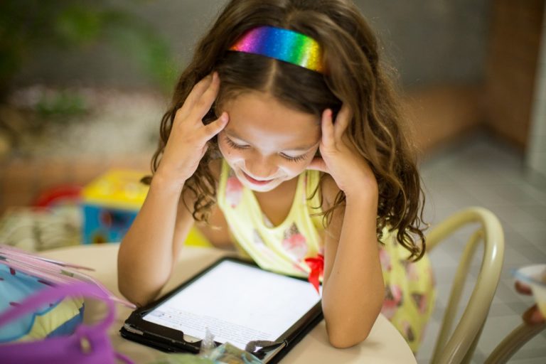 A child reads on a digital tablet.