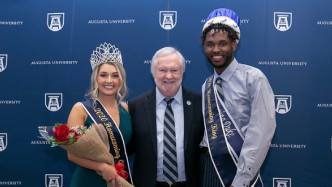 Homecoming king and queen with college president
