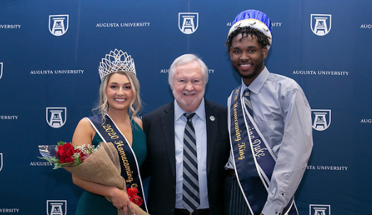 Homecoming king and queen with college president
