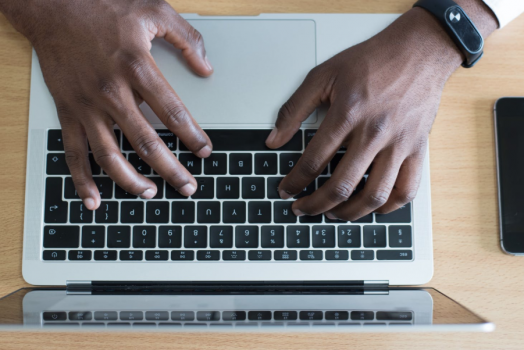 man typing on computer