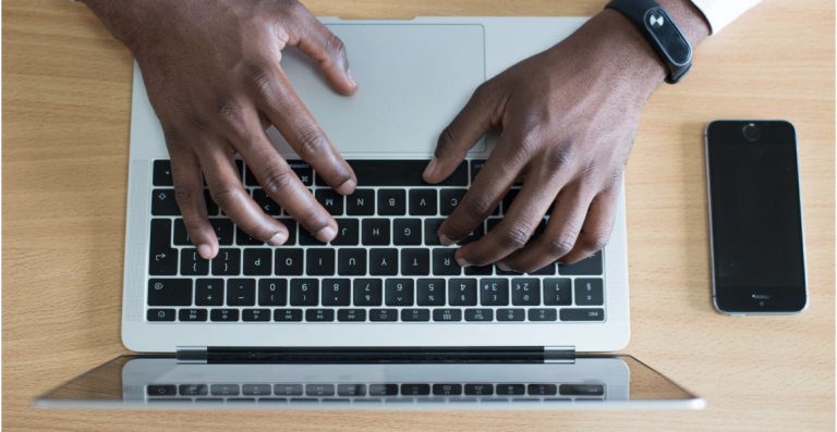 man typing on computer