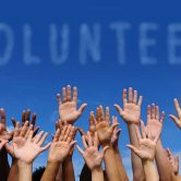 Volunteers raising hands