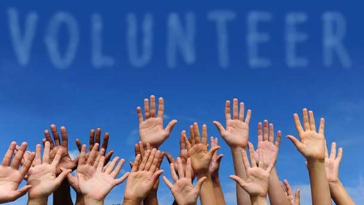 Volunteers raising hands