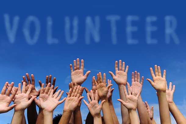 Volunteers raising hands