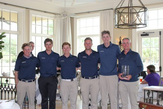 Men posing with trophy