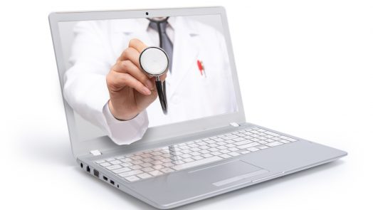 Telemedicine concept. Doctor with a stethoscope on the computer laptop screen.