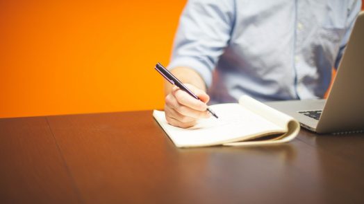 Person writing in notebook