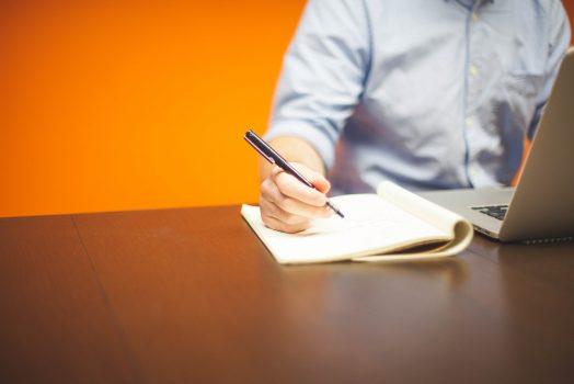 Person writing in notebook