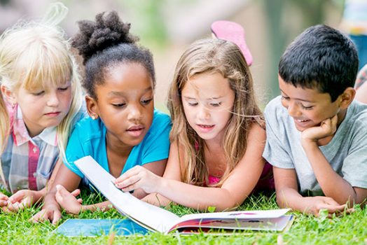 Kids reading on the ground.