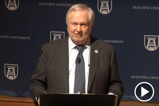 man talking with podium