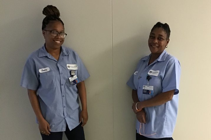two EVS female employees wearing light blue uniform shirts
