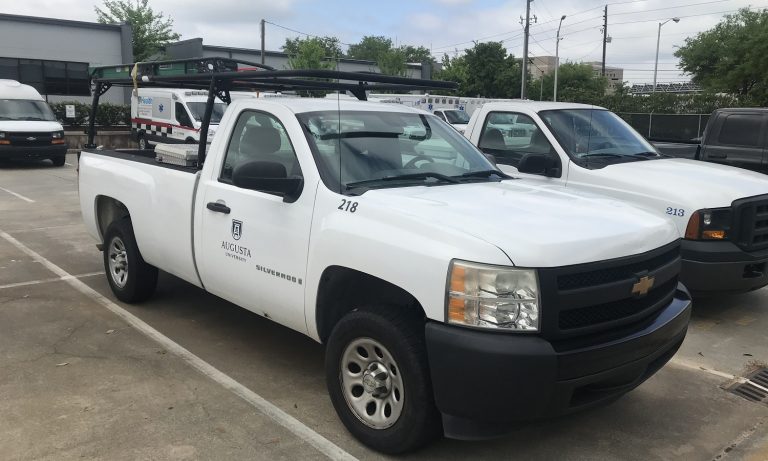 White work truck with Augusta University logo on passenger door